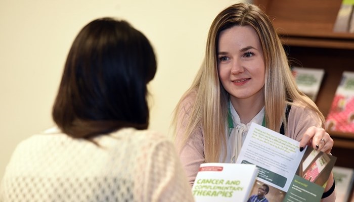 A volunteer from MacMillan Cancer Support charity speaking to a member of public
