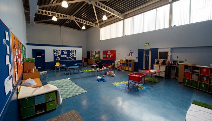 a large room with a tall ceiling equipped for children with toys