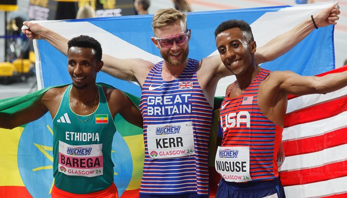 Josh Kerr holding the Scotland flag after winning gold in the 3000 metres at the World Athletics Indoor Championships in Glasgow. He is alongside silver medallist Yared Nuguse from the USA and Selemon Barega from Ethiopia who won bronze.