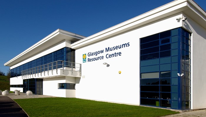 Exterior of Glasgow Museums Resource Centre. The centre is a large, white building with big glass windows. 