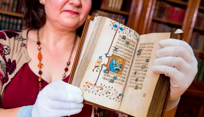Librarian Susan Taylor with Late 14th Century Book of Hours