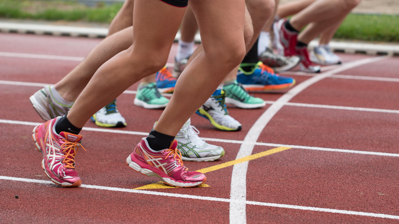 A group of ladies preparing to set off from the starting line on a running track