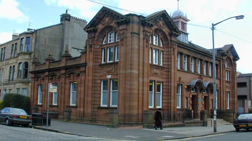 Pollokshields Library is a building made from red sandstone, situated on the corner of two streets.