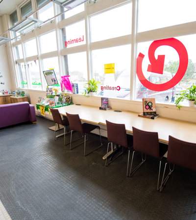 A view of Barmulloch Community Hub, showing a table and sofa