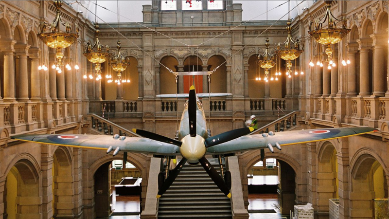 large spitfire engine hanging from the ceiling in a museum setting