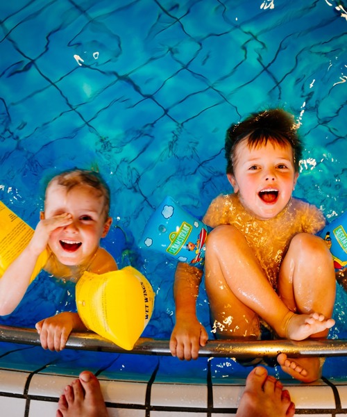two boys playing in swimming pool