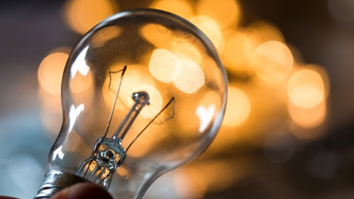A bulb pictured in front of glowing lights
