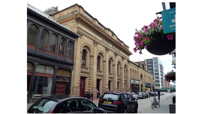 an image showing the front of Glasgow City Halls - the building has 5 tall archways along the facade.