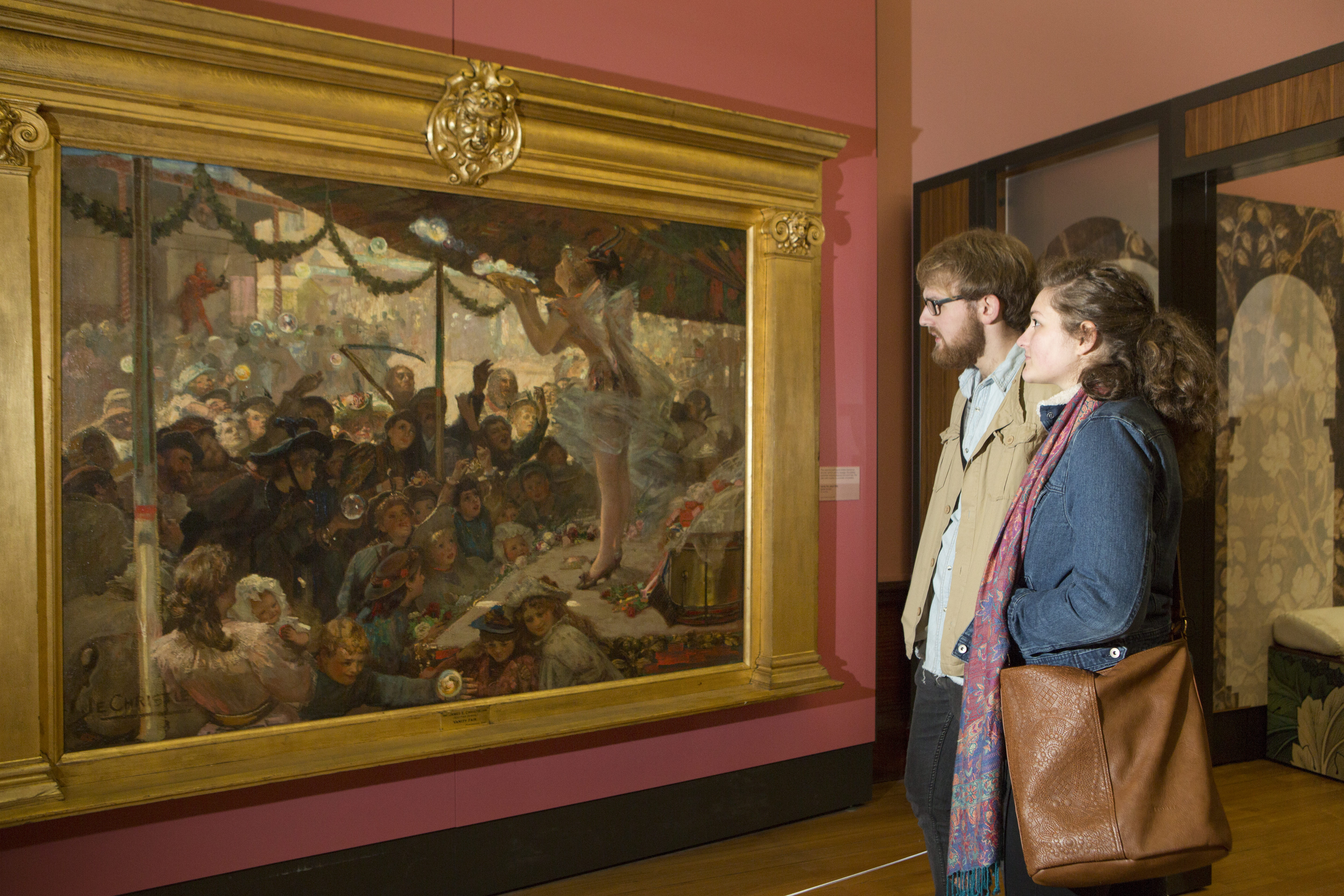 Two visitors to Kelvingrove Art Gallery and Museum looks at paintings