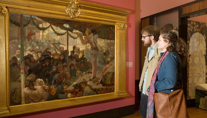 Two visitors to Kelvingrove Art Gallery and Museum looks at paintings