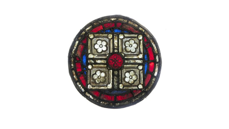 a stained glass roundel with various patterns inside