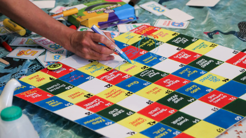 A close up someone playing a board game created by Swap Market.