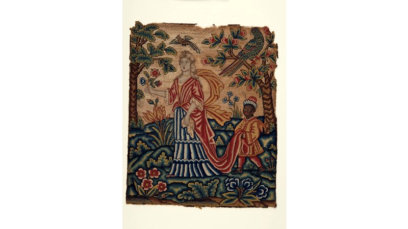 image of a colourful embroidered panel showing a person in the centre