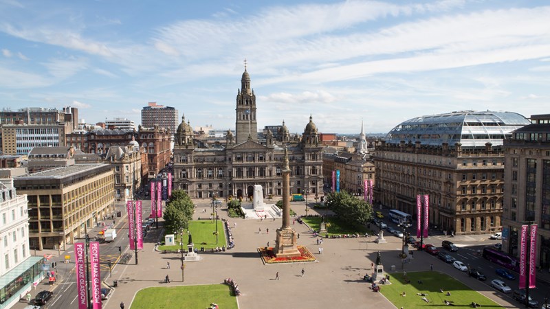 A picture of George Square and Glasgow City Chambers taken from the opposite side of the square.