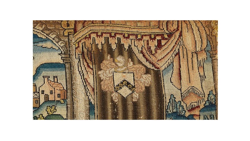 a close up of a gold coloured needlework.