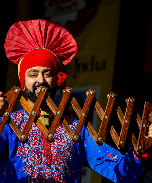 A performer poses in traditional South Asian costume