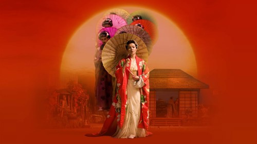 A performer dressed in a red and white kimono holding a circular paper parasol, against an orange background showing an image of a Japanese tea house