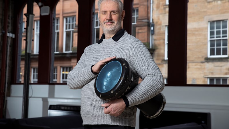 Conductor Paul MacAlindin poses with a drum 