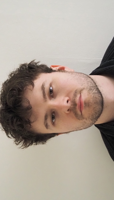 An image of a person against a white background looking at the camera