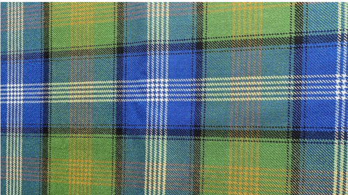 "Islamic Tartan fabric featuring a woven plaid pattern in green, royal blue, white, black, and subtle gold accents."