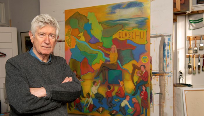 Image of the artist Sandy Moffat in front of one of his paintings