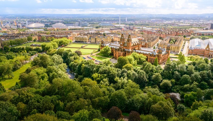 Aerial view of Kelvingrove Park with the trees in full leaf and Kelvingrove Art Gallery and Museum