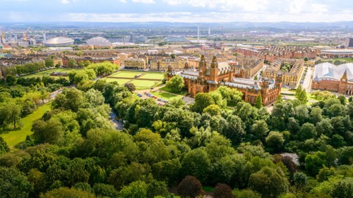 Aerial view of Kelvingrove Park with the trees in full leaf and Kelvingrove Art Gallery and Museum