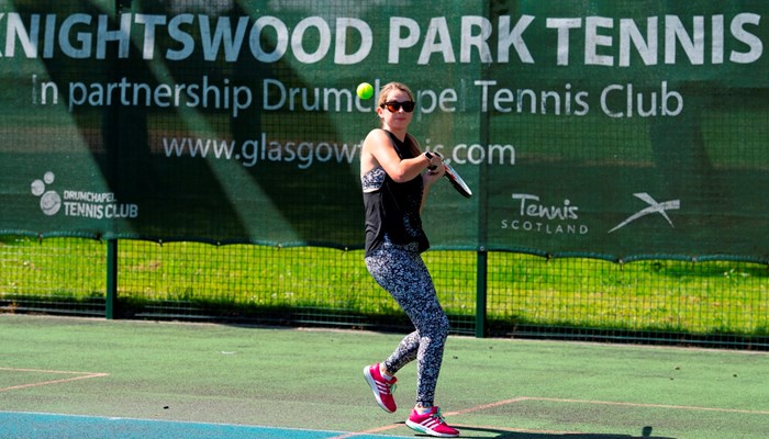 A person playing tennis at Knightswood Park