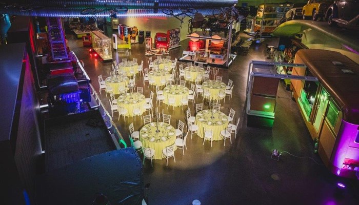 birds eye view of multiple tables set up for dinner with a white and yellow theme