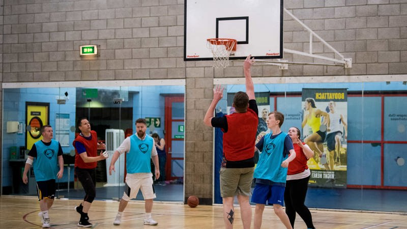 People playing basketball indoors