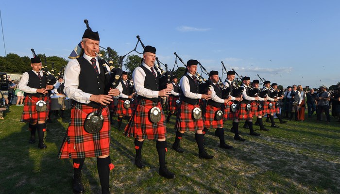 A group of pipers marching during the World Pipe Band Championships 2022 at Glasgow Green