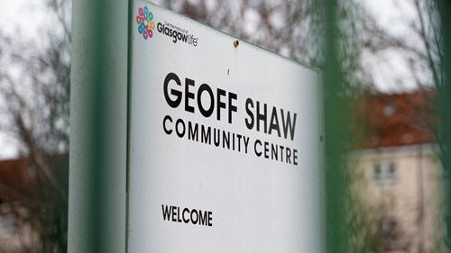 A close up image of white external signage, with text that says "Geoff Show Community Centre: Welcome" on it.