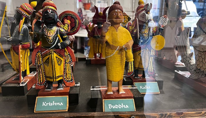 Photograph showing figurines of Krishna and Buddha on display in the reception area of GMRC.