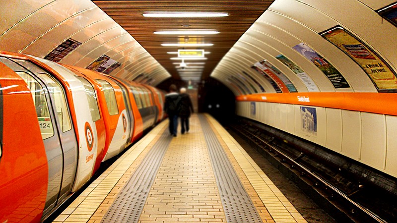 Photograph of the inside of Sheilds Road Subway station, with two people about to get on board.