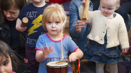Young children with percussion instruments taking part in a workshop