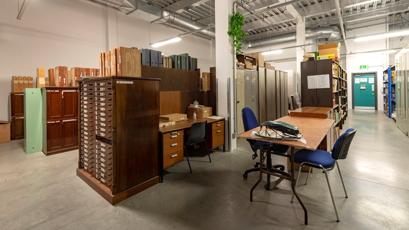 View of one of the storage pods inside GMRC with a large wood filing cabinet in foreground