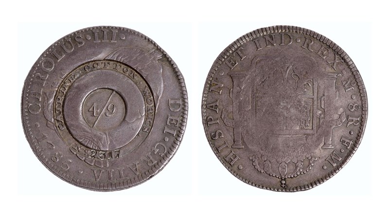 the front and back sides of a coin showing two patterns in bas-relief on the coin faces. one side shows a circular pattern whilst the other shows a coat of arms.
