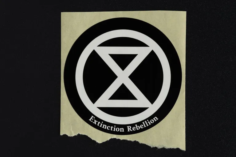photo of a sticker bearing the logo of Extinction Rebellion