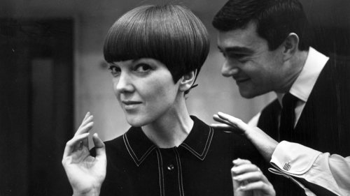 Black and white photograph of fashion designer Mary Quant. Mary Quant and Vidal Sassoon, 1964. © Ronald Dumont/Daily Express/Hulton Archive/Getty Images