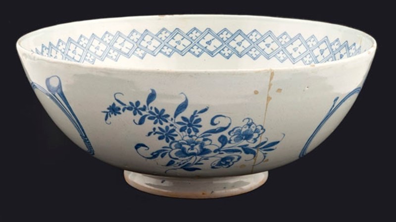 a white ceramic bowl with blue detailing