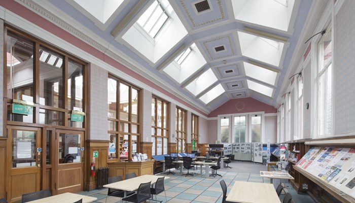 Large, bright reading room with huge windows surrounding the room and skylights