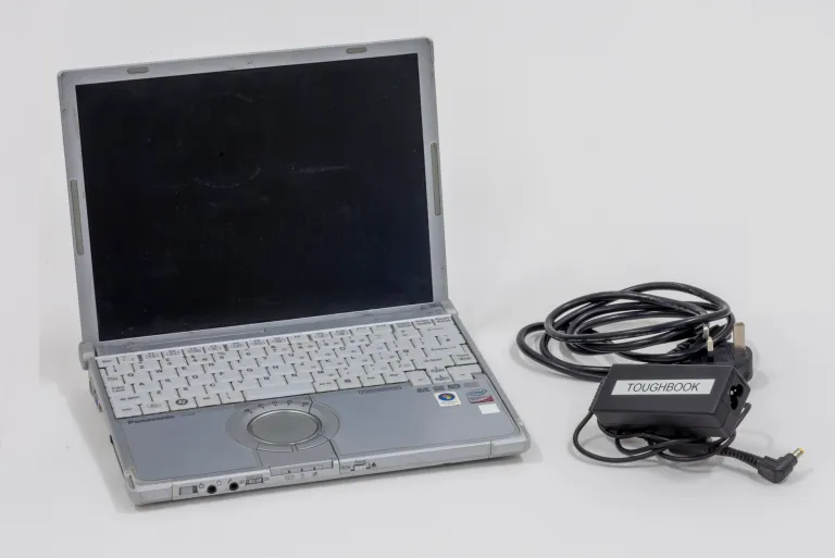 a photograph of a laptop and charger.