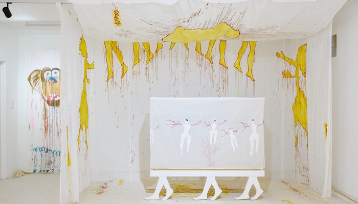 Contemporary yellow artwork on a white backdrop. The face of a brown dog has been painted on a separate canvas to the left.