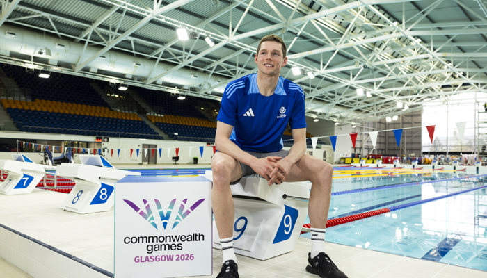 Swimmer Duncan Scott standing in front of the refurbished pool at Glasgow Club Tollcross