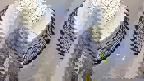 A vast banner, pictured from below, hangs in GoMA's grand main entrance