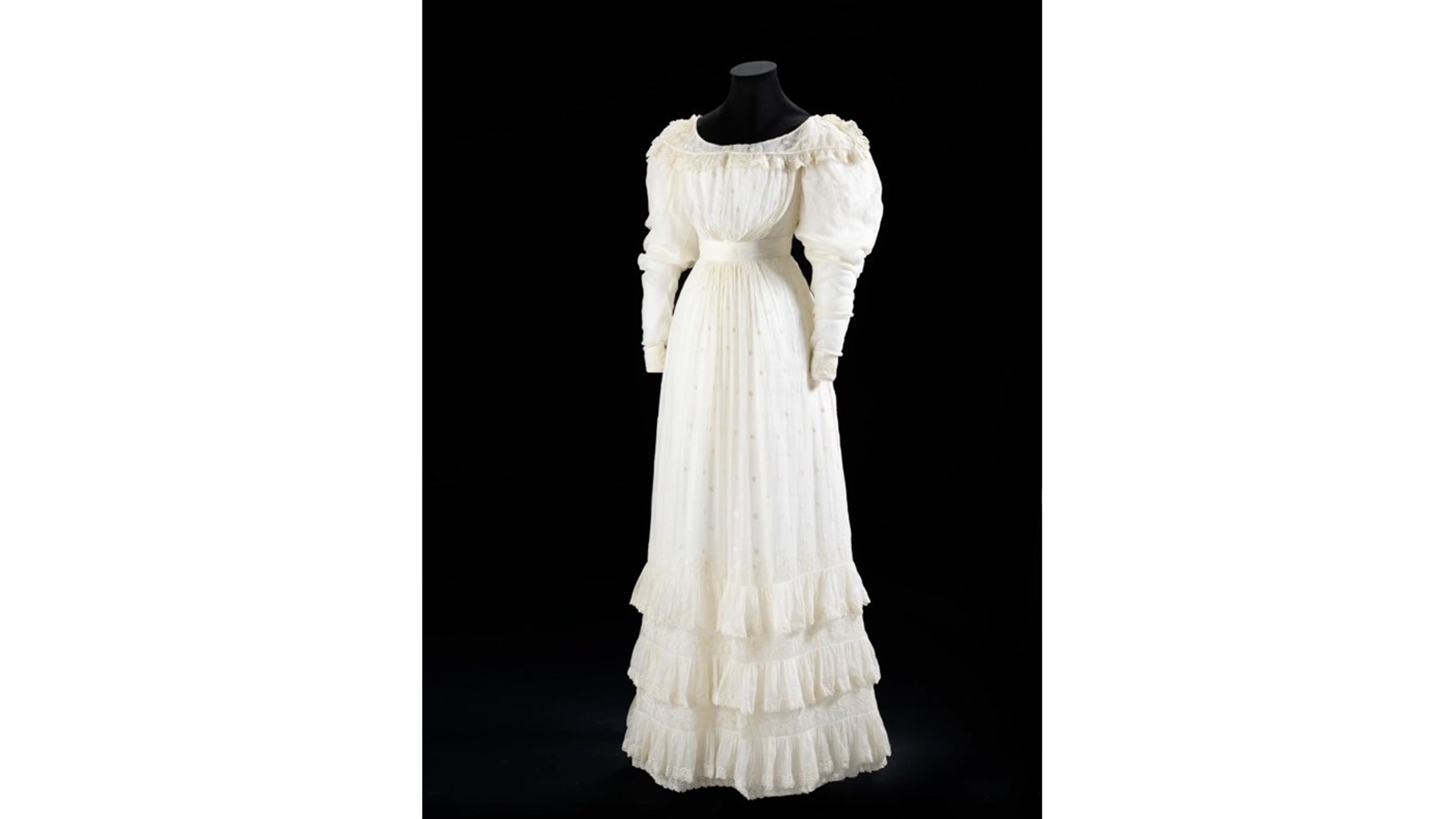 an image of a long white dress on a near invisible dummy.