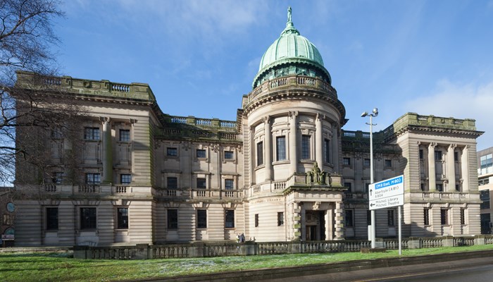 The Mitchell Library in Glasgow with a blue sky above