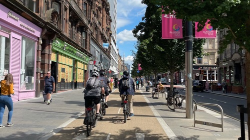 A group of cyclists on a cycle path in a city centre