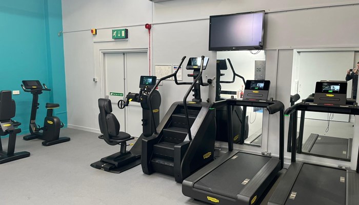 Wide angle view of the gym with treadmills, a Step machine and exercise bike