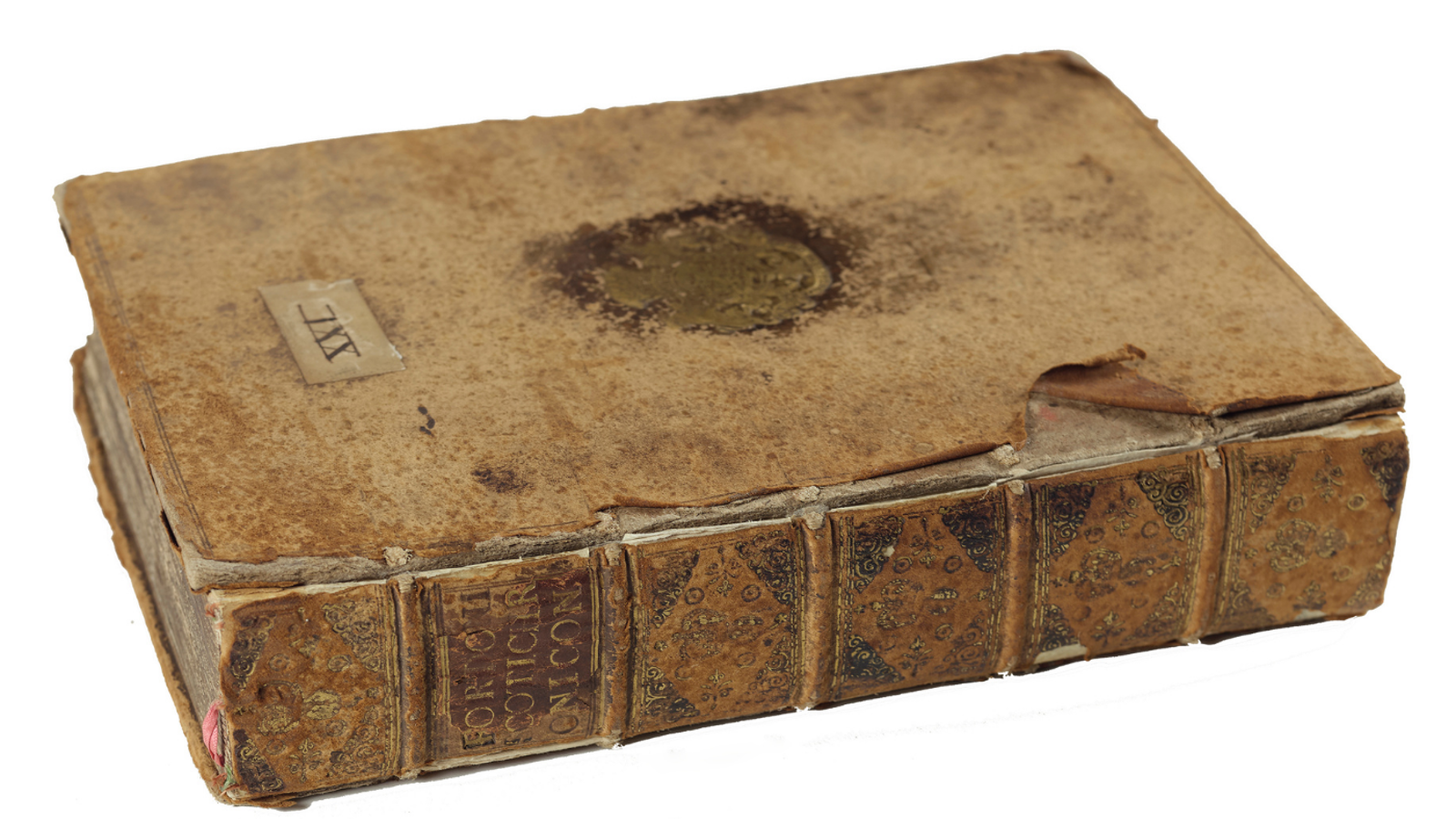 An antique bound manuscript lying closed, showing a weathered brown leather cover and a ribbed, gilded leather spine with the title "FORDUN SCOTICHRONICON".